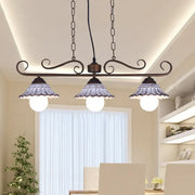 Antique bronze wrought iron island pendant lamp with three frosted glass shades and delicate ruffled edges