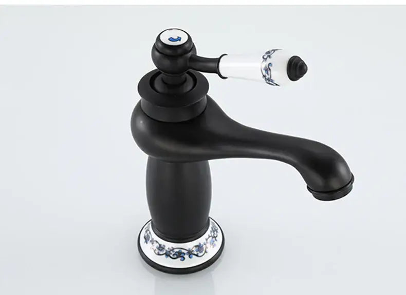DecorBites™ antique bronze single handle bathroom faucet with black matte finish and white ceramic base with blue floral real shot details