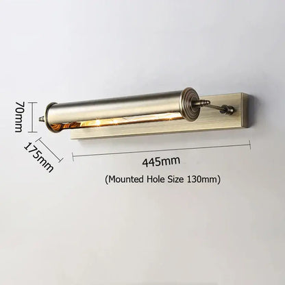 A sleek brushed brass cylindrical antique bronze bathroom wall lamp with adjustable arm and warm glass vanity light