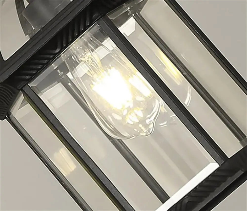 Antique bronze black outdoor pendant light lantern with clear glass panels and exposed filament bulb decorbites black outdoor hanging