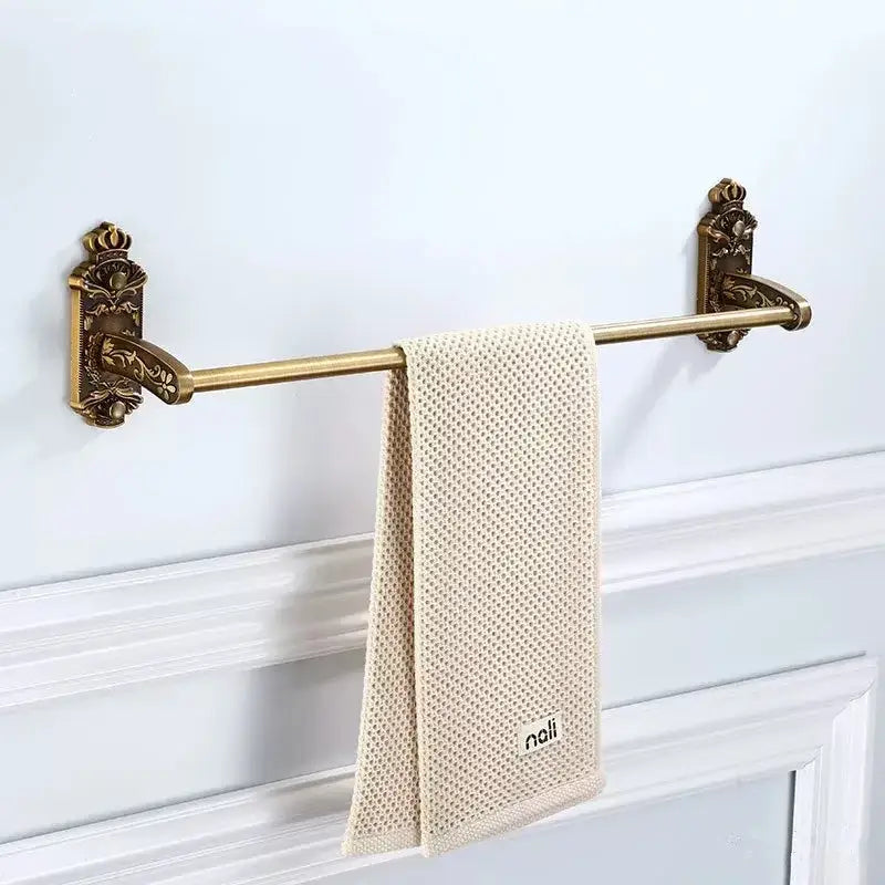 Antique bronze carved bath towel rack with ornate crown wall mounts and cream mesh towel for carved bath accessories decorbites