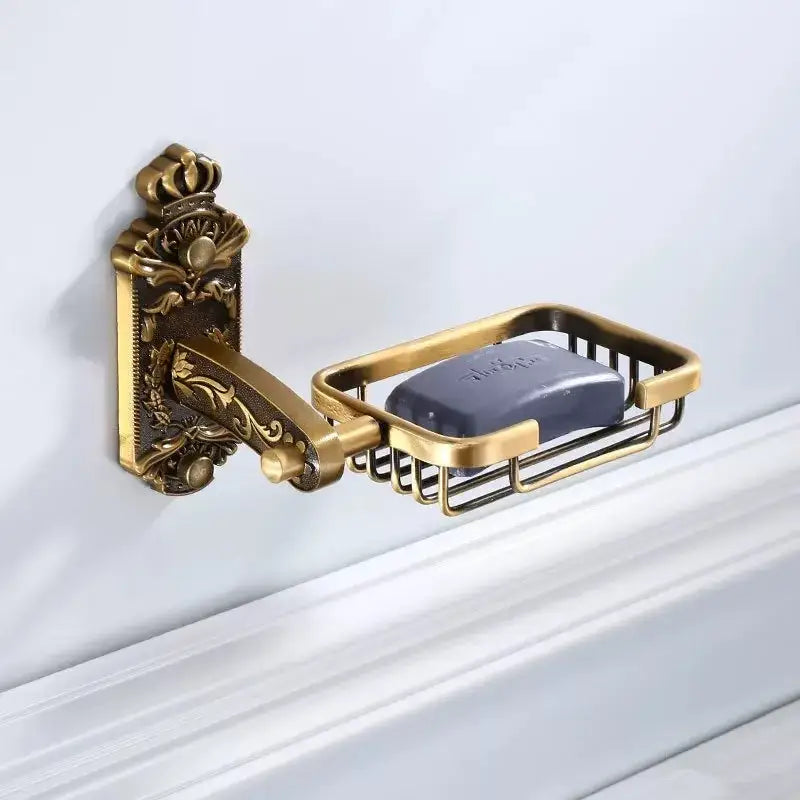 Antique bronze carved bath wall-mounted soap dish in brass with a dark gray soap bar for carved bath accessories decorbites