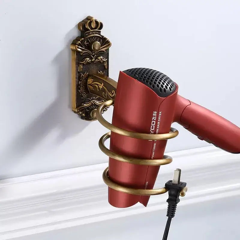 Red ycoz hair dryer with black mesh grille held in gold-toned decorbites bronze carved bath wall rack holder