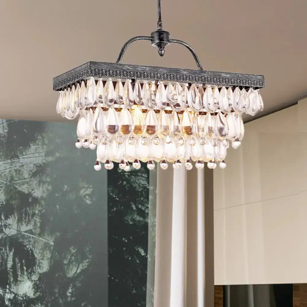 Antique bronze rectangular chandelier featuring clear crystal teardrop accents for dining room lighting