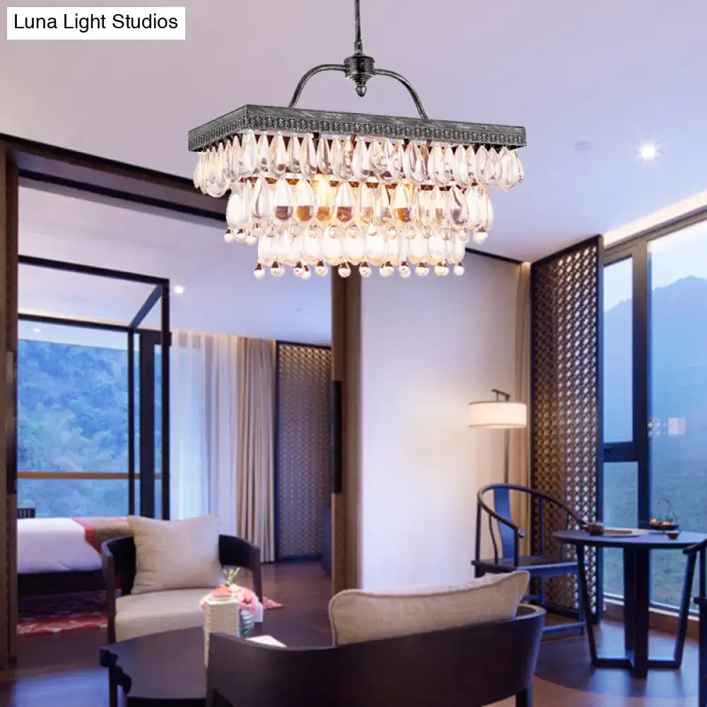 Antique bronze rectangular chandelier with clear crystal teardrops and dark metal frame for dining room lighting