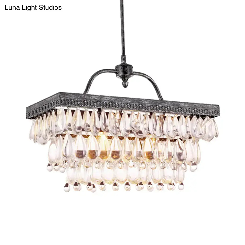 Antique black metal chandelier with multiple tiers of clear crystal teardrop accents for dining room lighting