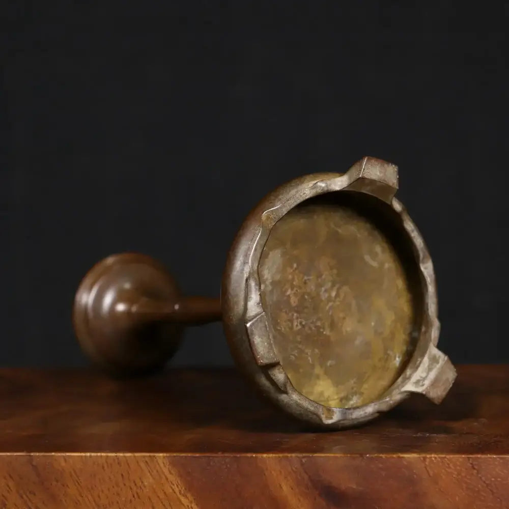 Antique bronze crane incense burner featuring an antique brass mortar with a rounded tarnished bowl and dark wooden handle