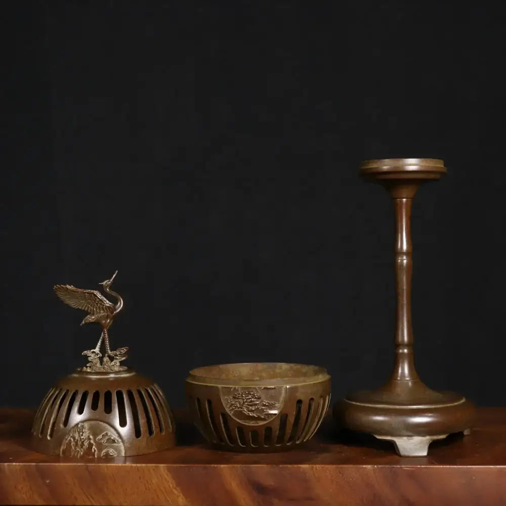 Antique bronze crane incense burner with ornate finial and perforated base for living room decor by decorbites