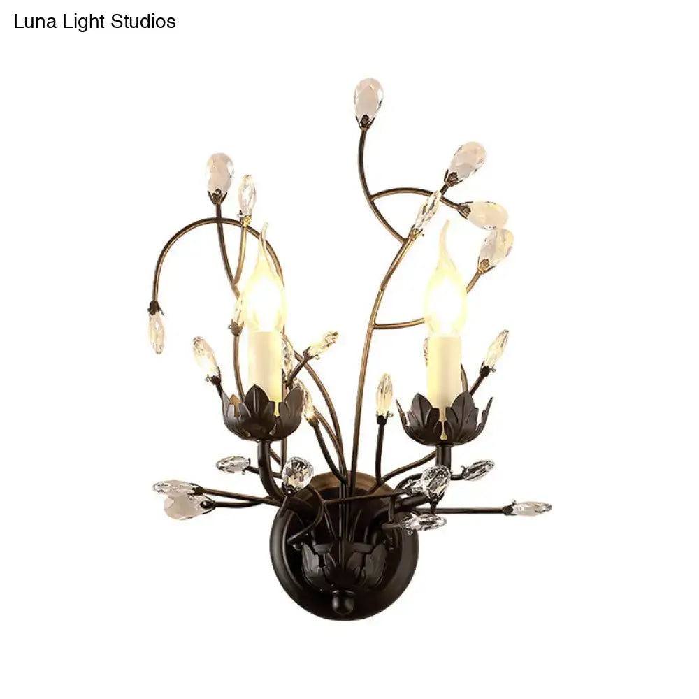 Elegant black wrought iron wall light with crystal accents and two candle-style bulbs for living room use