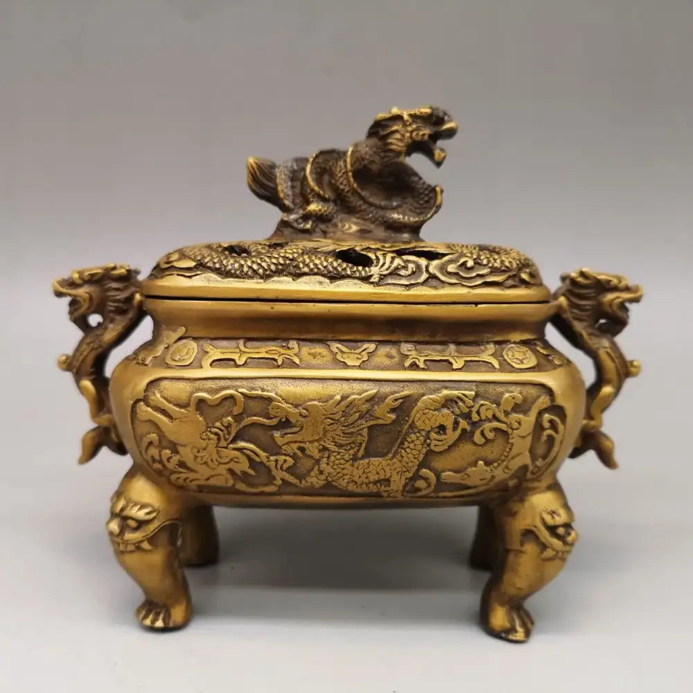 Golden brass incense burner with intricate double dragon lion motifs and lion-shaped feet for living room decor