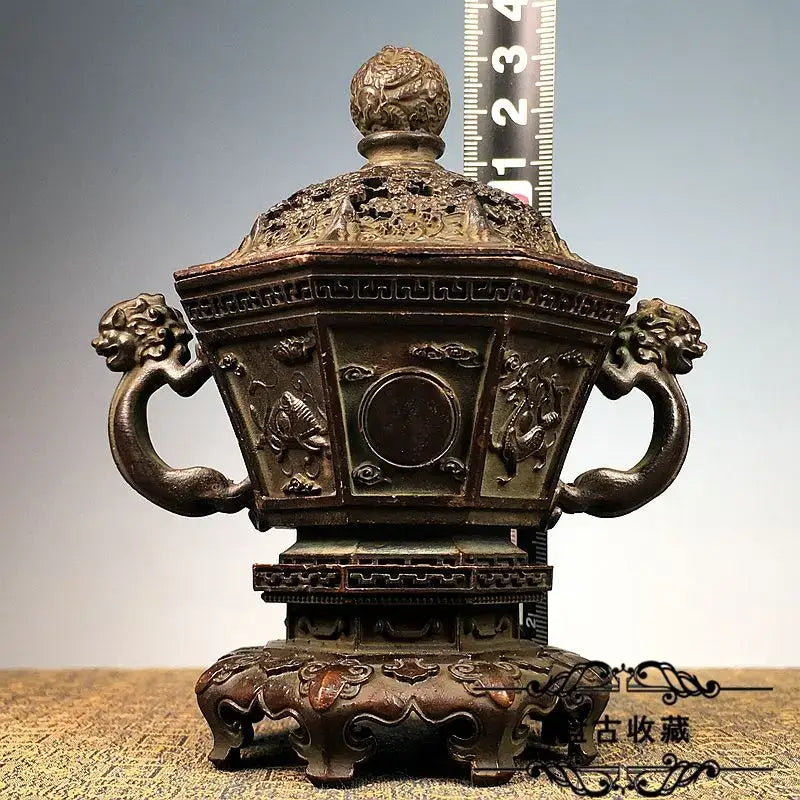 Antique bronze dragon incense burner set with hexagonal body, lion-head handles, and intricate cloud carvings for decor