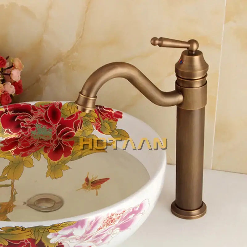 Antique brass single-handle bathroom faucet with ornate handle and curved swivel spout for decorbites bronze finish bathroom sink