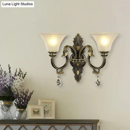 Antique bronze wall mounted two-light fixture with frosted glass shades and gold crystal droplets for bedroom e26 e27