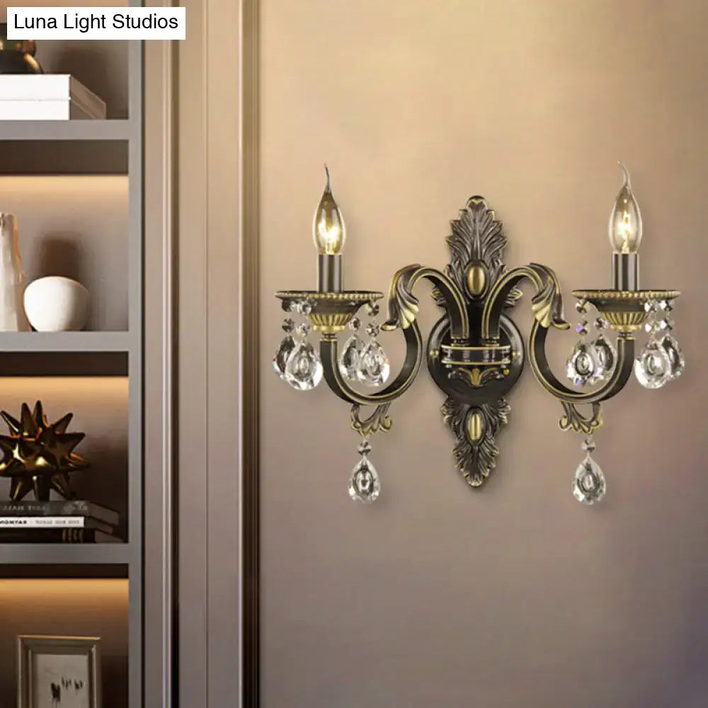 Antique bronze and gold nordic wall mount light with brass and crystal two-light sconce featuring ornate leaf motifs