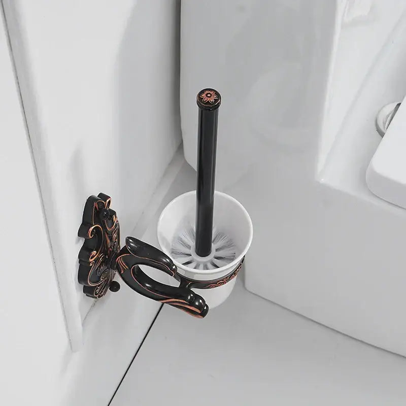 Antique bronze ornate ceramic toilet brush holder set with black-handled toilet brush and white ceramic base