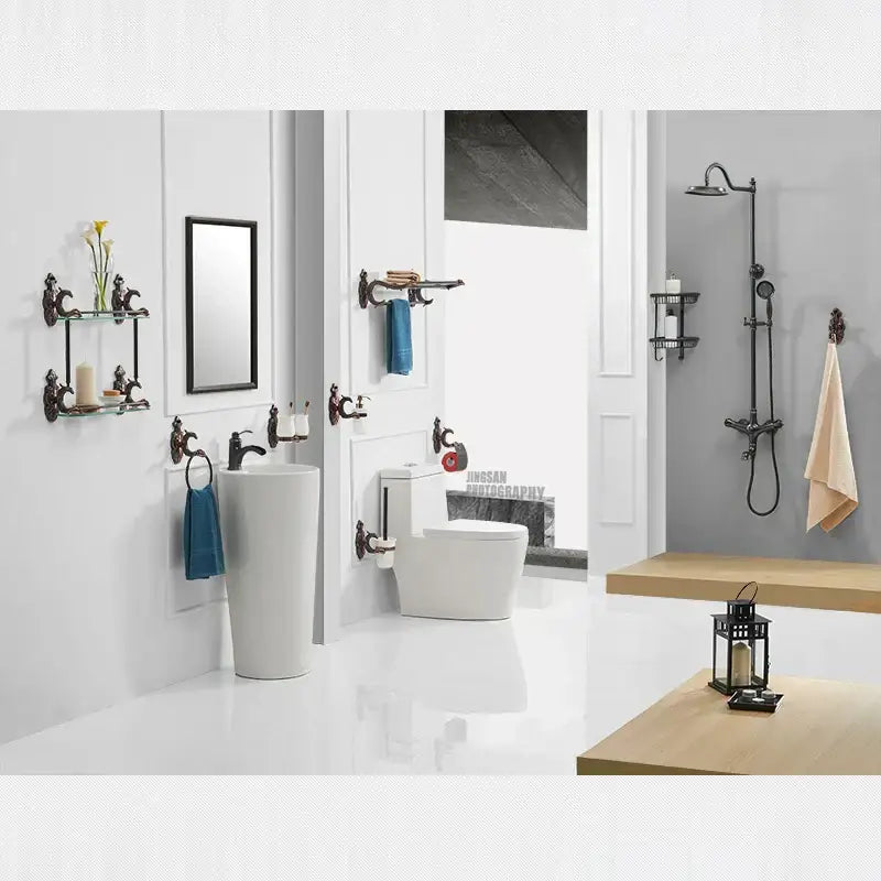 Black wrought iron shower fixture with chrome accents paired with antique bronze ornate ceramic toilet brush holder set