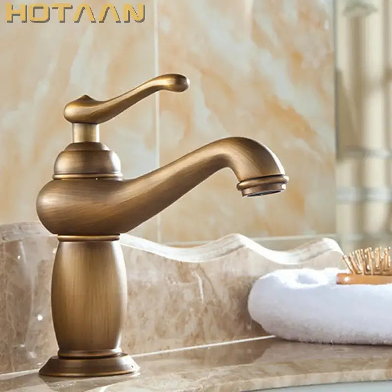 Antique bronze single handle basin faucet with brass finish, classic curved spout, and ornate base for bathroom use