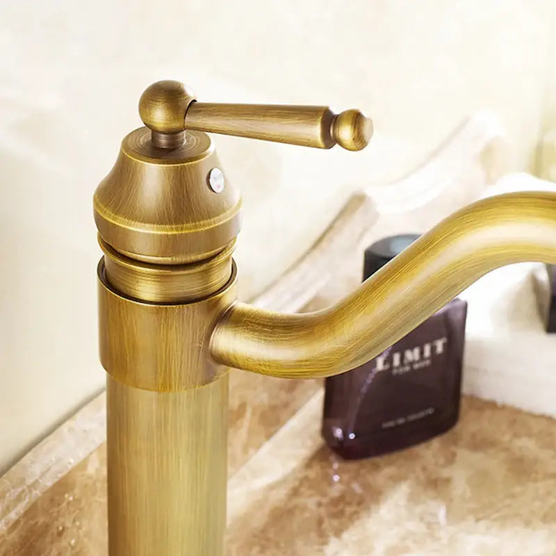 Antique bronze tall bathroom sink faucet mixer with brass finish, single handle, curved spout, and ornate turned handle