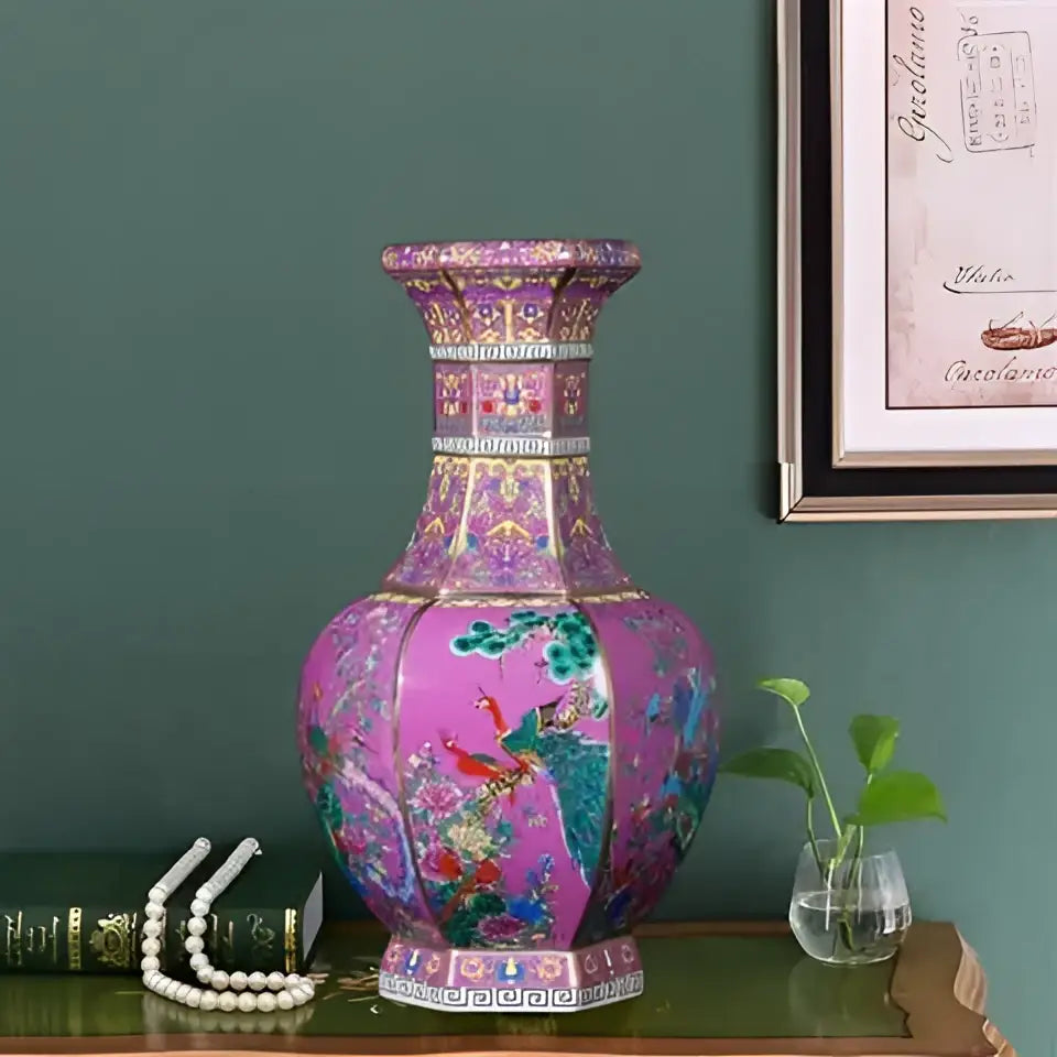 A vibrant pink antique ceramic vase 24cm with intricate gold and multicolored floral patterns and hexagonal base