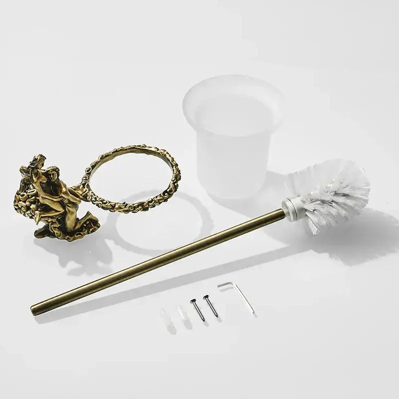 Brass toilet brush holder with ornate cherub handle and white bristle head in antique gold and silver finish bathroom set