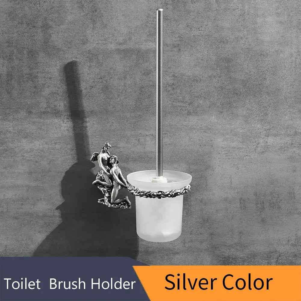 Antique cherub gold and silver toilet brush holder with silver-toned ornate metal bracket and frosted glass base