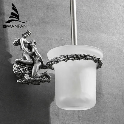 Antique silver-toned toilet brush holder with ornate cherub sculptural base and frosted glass cup brush holder