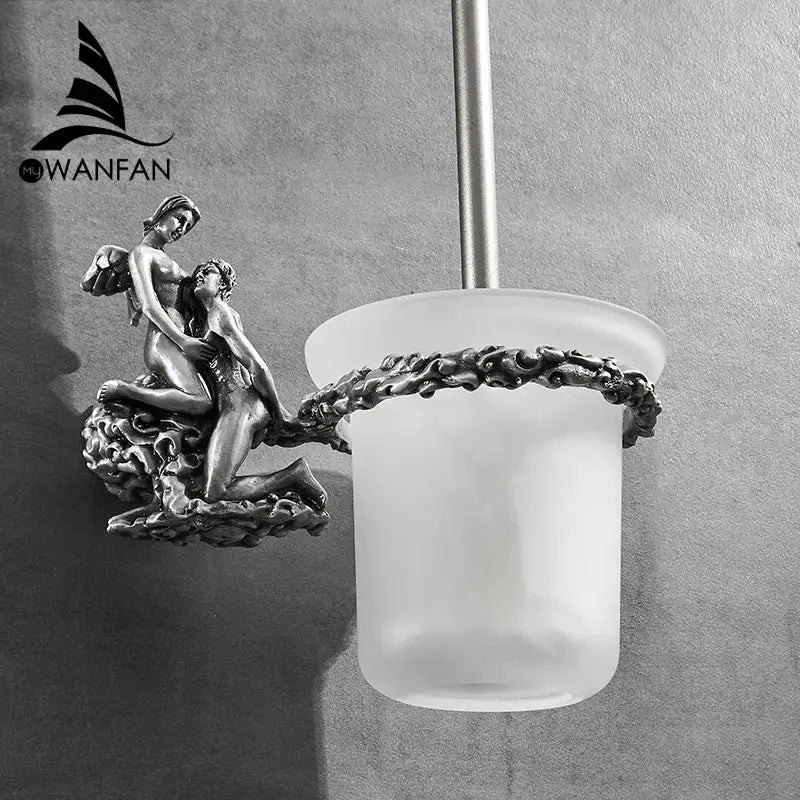 Antique silver-toned toilet brush holder with ornate cherub sculptural base and frosted glass cup brush holder