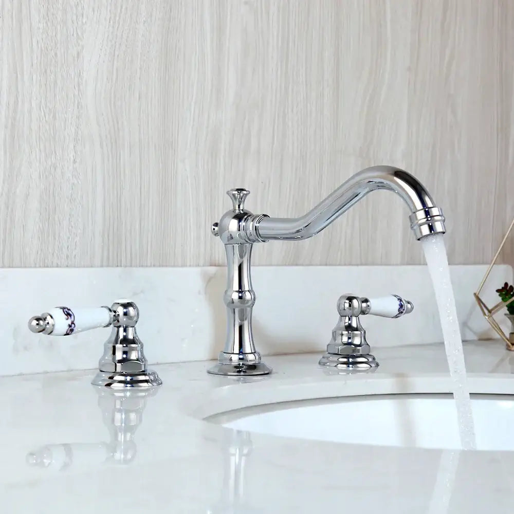Antique chrome and black basin faucet with curved spout and chrome finished dual handle porcelain decorbites dual handle