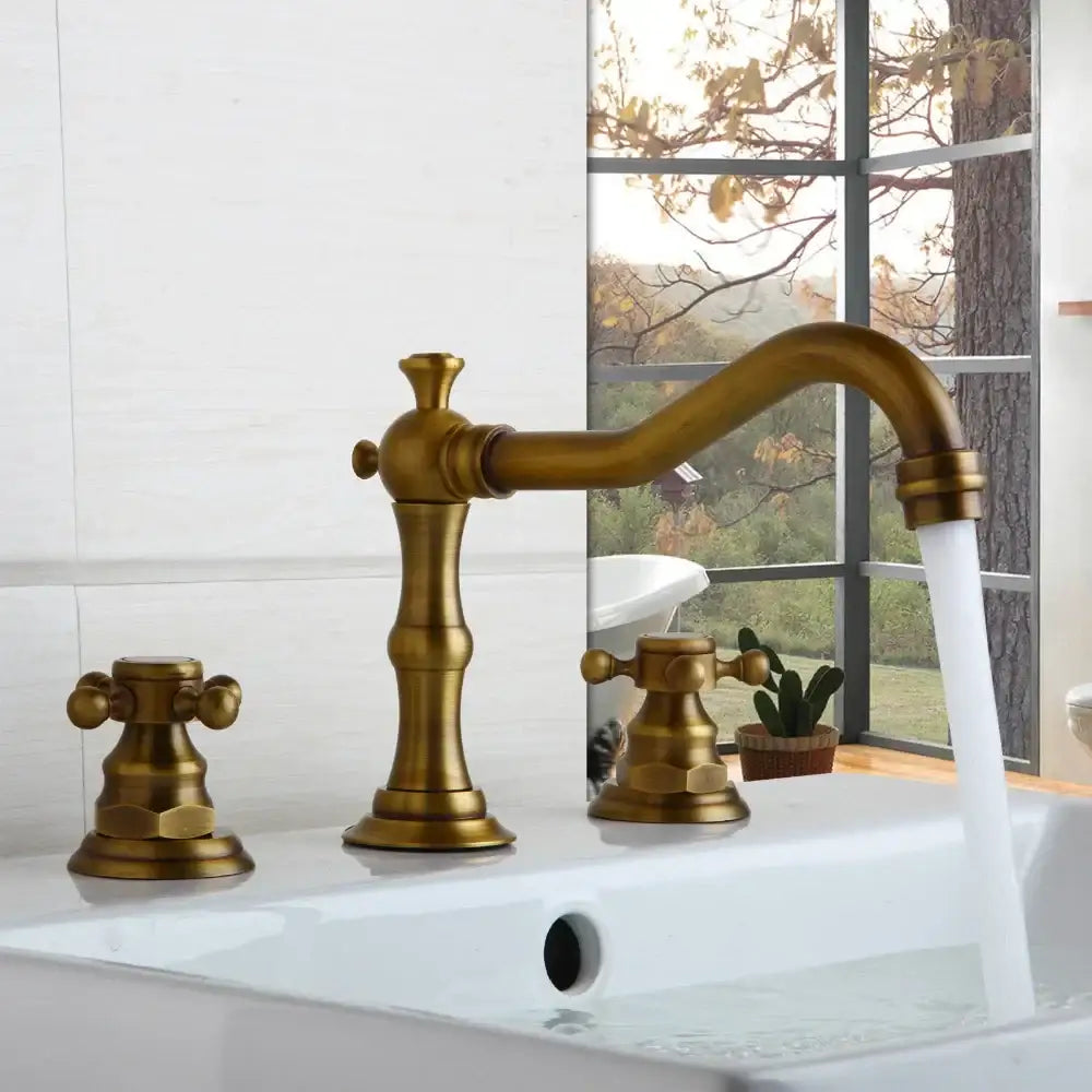 Antique brass-finished three-handle basin faucet with ornate vintage design and curved spout by decorbites dual handle
