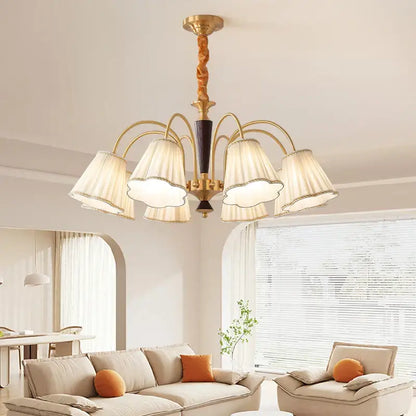 Antique copper chandelier with gold-toned twisted wooden stem and five cream pleated fabric shades for dining room