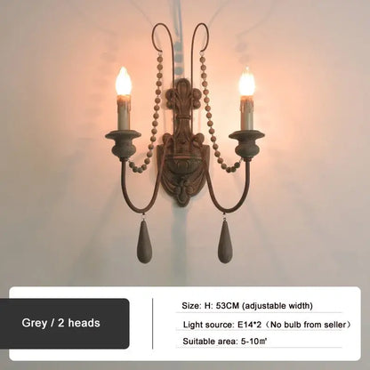 Antique country french wall lamp with grey metal sconce, two candle arms, beaded chains, and teardrop pendants decorbites country french wall