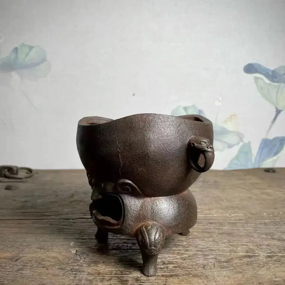Dark brown cast iron incense burner with animal-shaped legs and ring handles for antique double dragon copper craft carbon stove