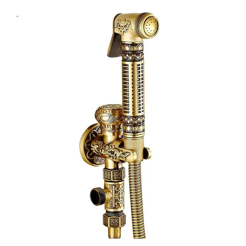 Antique engraved brass bidet shattaf in gold with ornate floral and geometric detailing for hygienic bathroom use