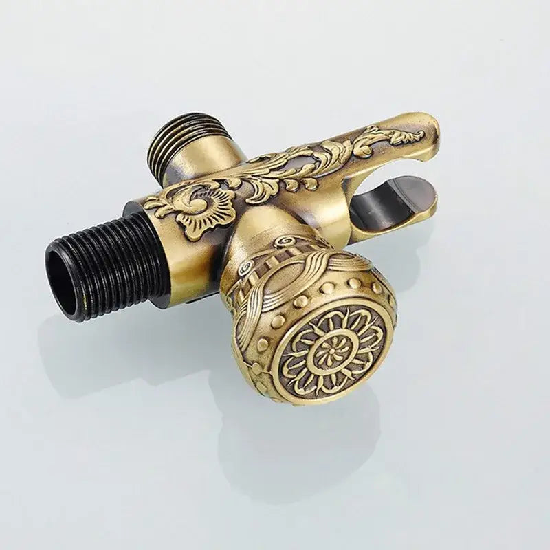 Antique engraved brass bidet shattaf with intricate floral and sunburst designs for hygienic bathroom washing