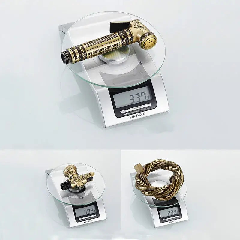 Antique engraved brass bidet shattaf with ornate detailing and coiled hose for bathroom hygienic washing