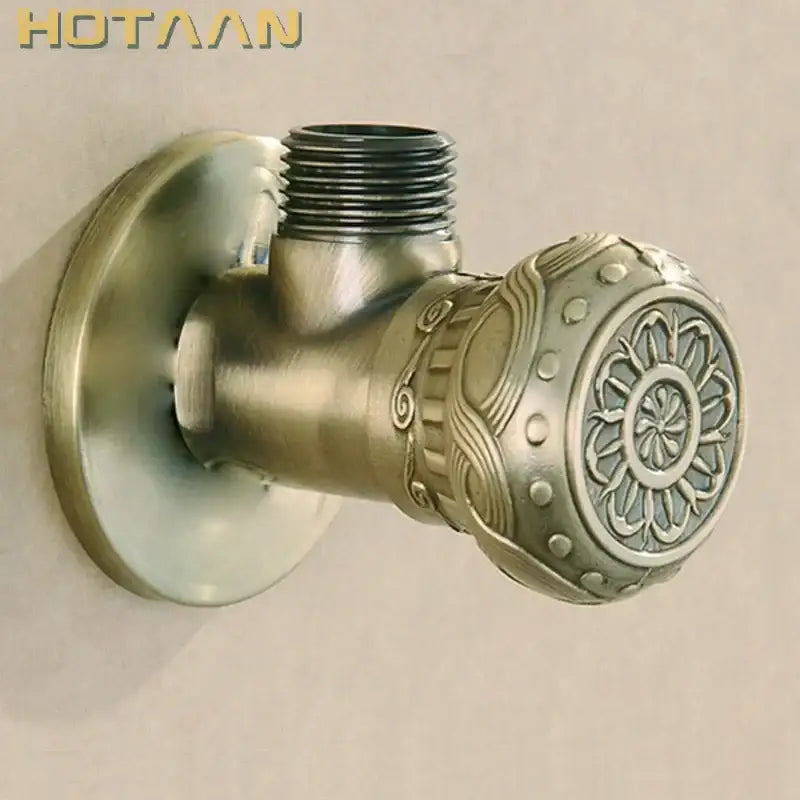 Antique engraved brass triangle valve bathroom faucet with ornate floral and scrollwork brass triangle handle detailing