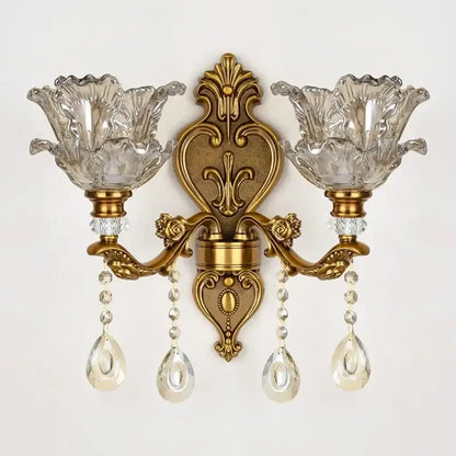 Antique european brass wall lamp with gold-toned ornate design and decorbites crystal glass dual flower-shaped shades