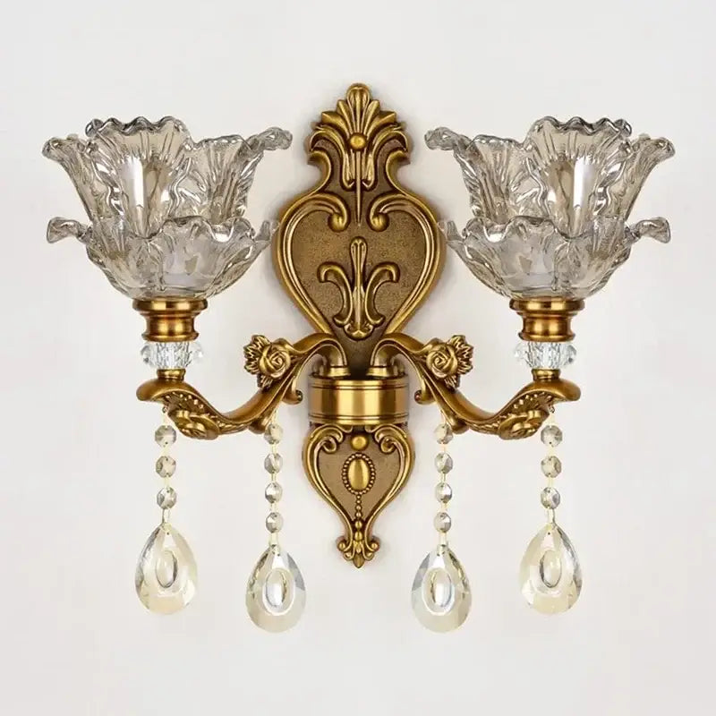Antique european brass wall lamp with gold-toned ornate design and decorbites crystal glass dual flower-shaped shades