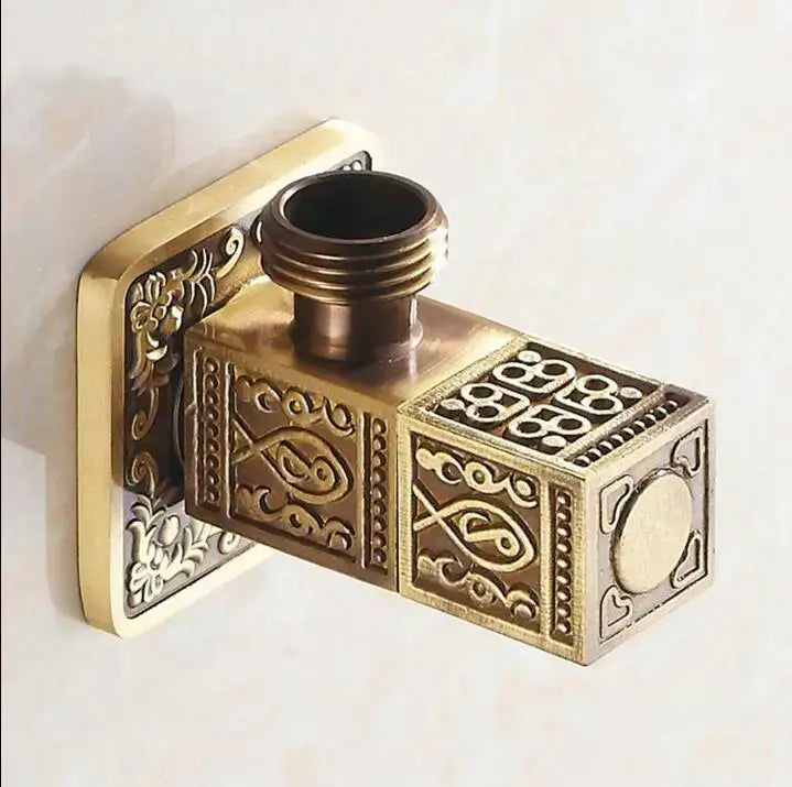 Antique floral brass bathroom angle stop valve with intricate fish and floral embossed designs on rectangular body