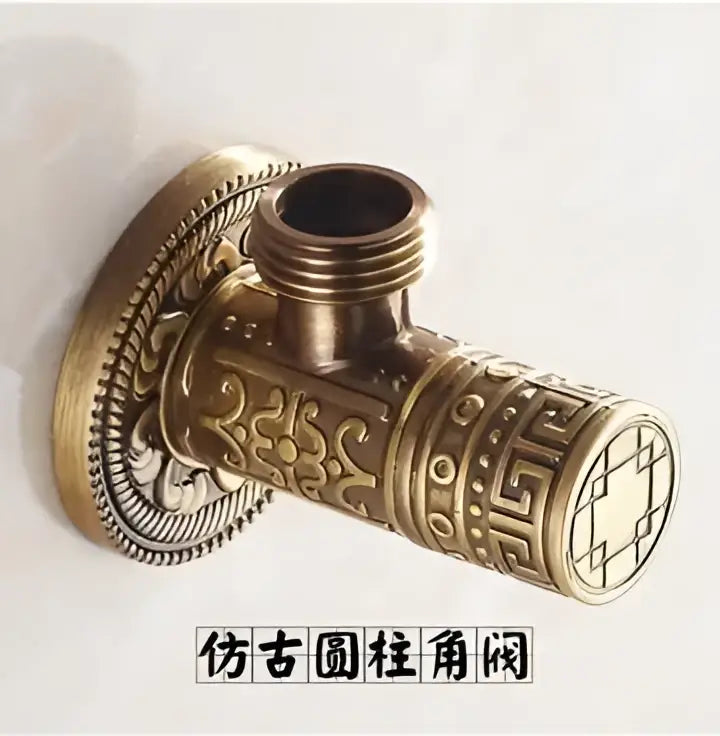 Antique floral brass angle stop valve with brass finish and intricate geometric scrollwork detailing