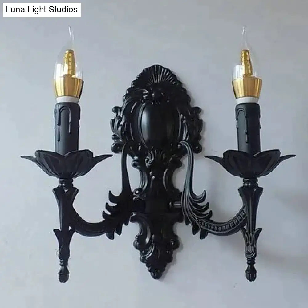 Black ornate wrought iron creative retro european wall sconce with two candle arms and gold-finished bulb holders
