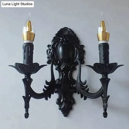 Black ornate wrought iron creative retro european wall sconce with two candle arms and gold-finished bulb holders