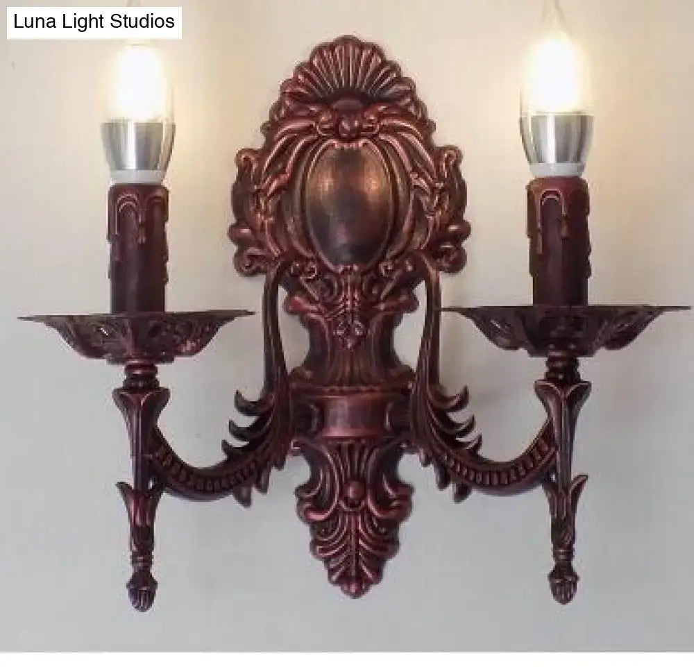 Antique gold retro european wall light featuring an ornate bronze-colored bronze sconce with two candle-shaped bulbs