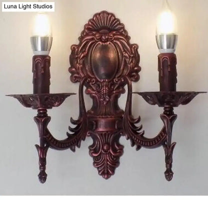 Antique gold retro european wall light featuring an ornate bronze-colored bronze sconce with two candle-shaped bulbs