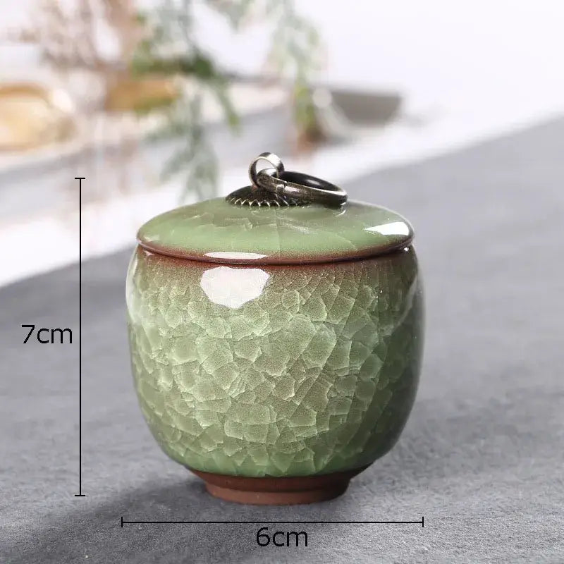 Antique green ceramic tea caddy with ice cracked texture glaze and silver metal ring handle for kitchen storage