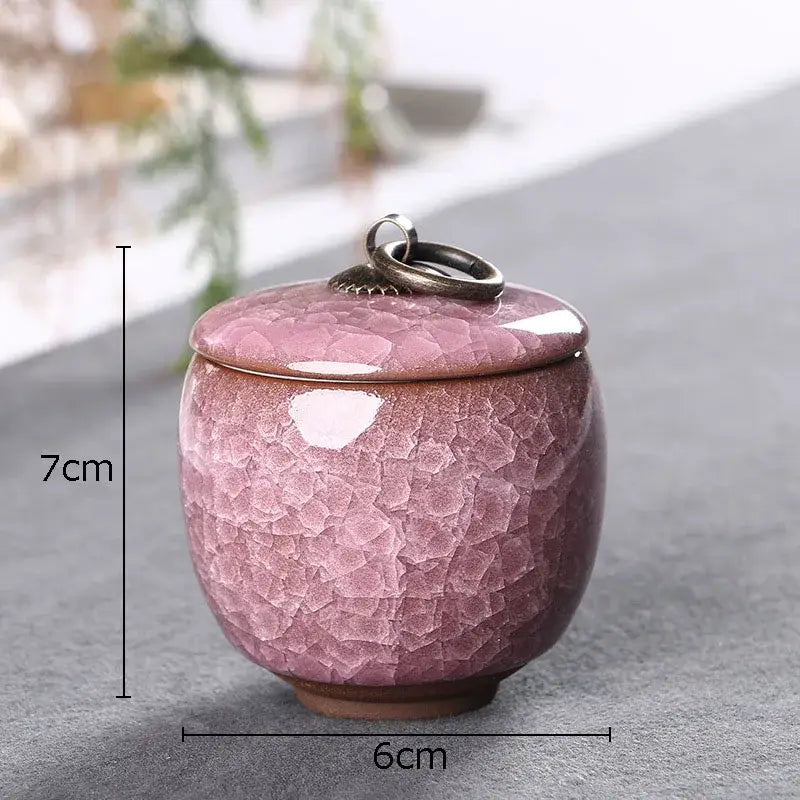 Antique green ceramic tea caddy with ice cracked texture and matching lid featuring metallic ring handle