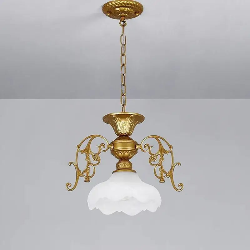 Antique industrial black and gold loft chandelier with gold-toned ornate scrollwork and white petal-shaped glass shade decorbites industrial loft
