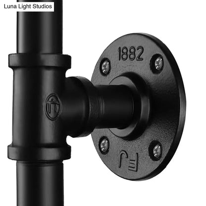 Aplique de pared antiguo industrial de metal negro con forma de tubo de agua y válvula, para comedor, con una bombilla.