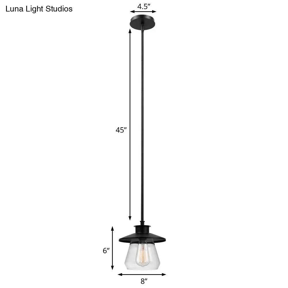 Lámpara colgante de metal antiguo negro con pantalla de cristal transparente para iluminación de techo en el comedor.