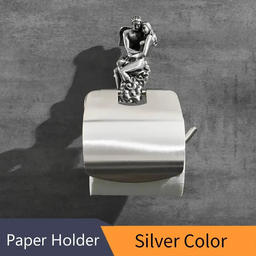 Silver metallic toilet paper holder with ornate sculpted couple atop antique bronze bathroom decor sculpture